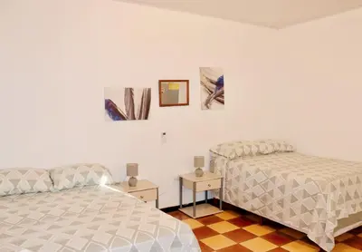 two beds sitting next to each other in a bedroom at Apartamentos Estudio Junto al Mar in Puntarenas