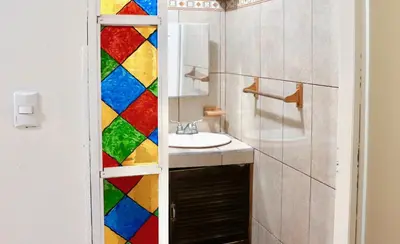 a bathroom with a sink and a mirror at Apartamentos Estudio Junto al Mar in Puntarenas
