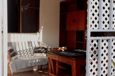 a room with a table and a couch and a chair at Apartamentos Estudio Junto al Mar in Puntarenas