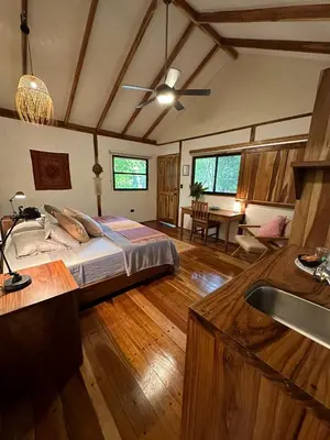 a large bedroom with a bed and a kitchen at Tierra Encantada Wellness Center in Nosara