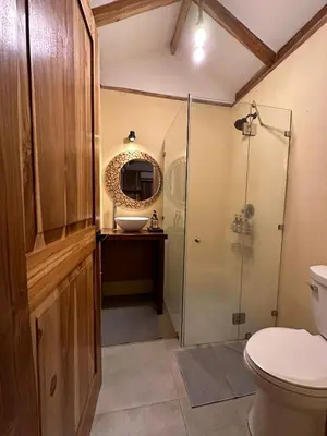 a bathroom with a shower and a sink and a toilet at Tierra Encantada Wellness Center in Nosara