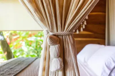 a curtain on a bed in a bedroom at Tierra Encantada Wellness Center in Nosara