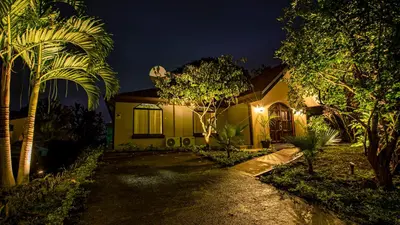 a house at night with a pathway leading to it at Anthurium house in Fortuna