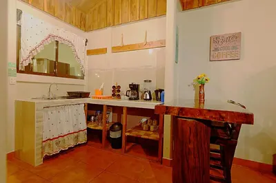 a kitchen with a counter and a sink at Arenal Dream Cottage in Fortuna