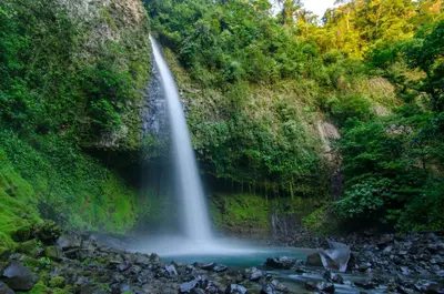 a waterfall in the middle of a river at Arenal Dream Cottage in Fortuna