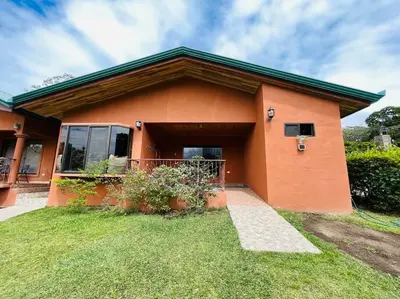 a orange house with a green roof at TucanTico Lodge ~ Casa # 3 in Monteverde Costa Rica