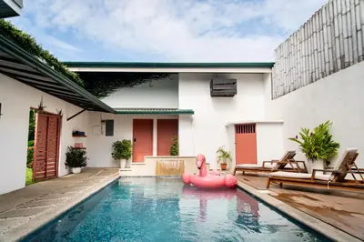 a pool with a pink rubber duck in the middle of a house at Hotel Por Que No? in Uvita