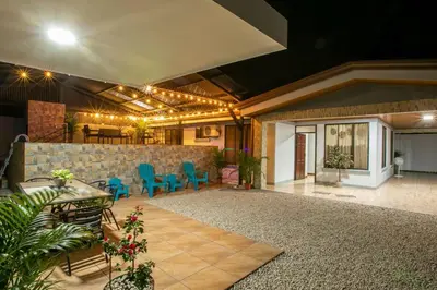 a living room with blue chairs and a table at Villa Buganvilia Fortuna Centro in Fortuna