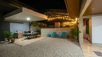 a living room with a table and blue chairs at Villa Buganvilia Fortuna Centro in Fortuna