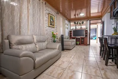 a living room with a couch and a television at Villa Buganvilia Fortuna Centro in Fortuna