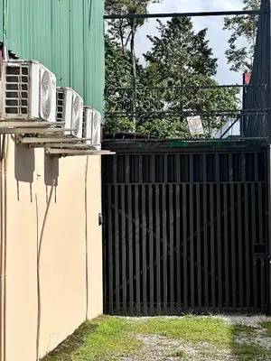 a fence with a radiator on the side of a building at Villa Buganvilia Fortuna Centro in Fortuna