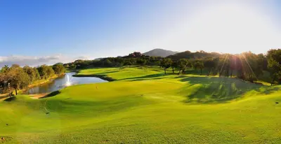 an aerial view of a golf course with a river at Modern 3BR Condo with Partial Ocean View - Carao - Reserva Conchal Golf Resort in Playa Conchal