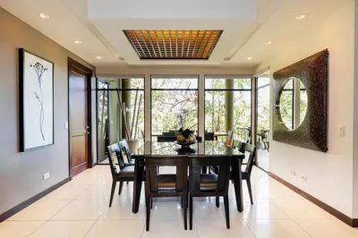 a dining room with a table and chairs at Modern 3BR Condo with Partial Ocean View - Carao - Reserva Conchal Golf Resort in Playa Conchal