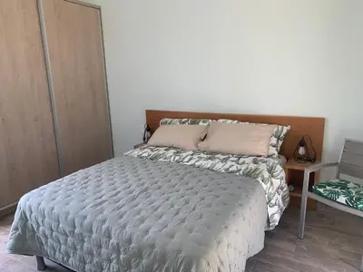 a bedroom with a large bed with a white comforter at Incroyable Villa HermoSamara in Sámara