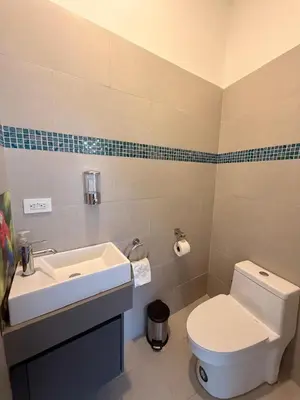 a bathroom with a white toilet and a sink at Incroyable Villa HermoSamara in Sámara