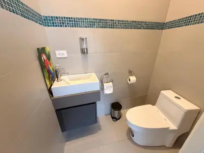 a bathroom with a white toilet and a sink at Incroyable Villa HermoSamara in Sámara