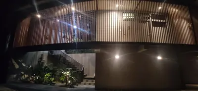 a lobby with stairs and plants in a building at Incroyable Villa HermoSamara in Sámara