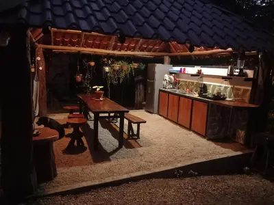 an outdoor kitchen with a table and a table at Aura Bungalow 2 in Tamarindo