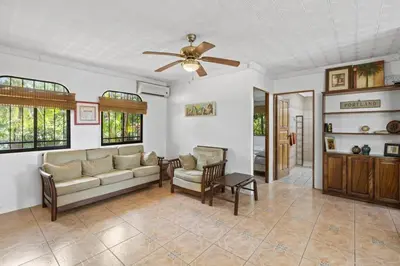 a living room with a couch and a ceiling fan at 2-Bedroom House with Pool in Playa Flamingo