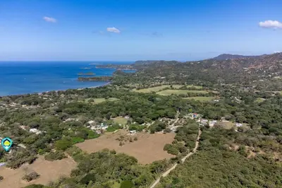 an aerial view of a town next to the ocean at 2-Bedroom House with Pool in Playa Flamingo