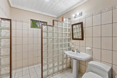 a bathroom with a toilet and a sink at 2-Bedroom House with Pool in Playa Flamingo