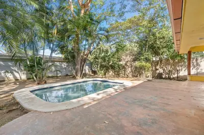 a swimming pool in the middle of a yard at 2-Bedroom House with Pool in Playa Flamingo