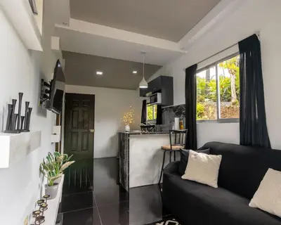 a living room with a couch and a table at Villa el Descanso in San Pedro