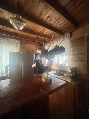 a kitchen with a table with a pot on it at Cabaña Trojas Valverde Vega in Trojas