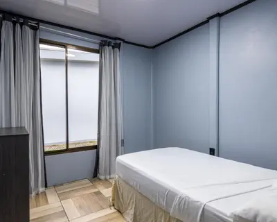a bedroom with a bed and a large window at La Casa del Tío Carlos in San Pedro