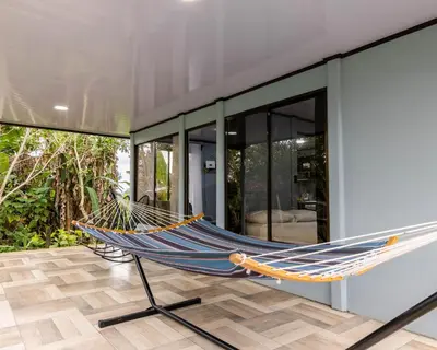 a hammock on the porch of a house at La Casa del Tío Carlos in San Pedro