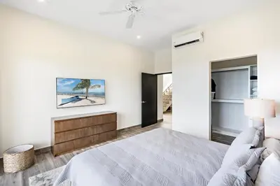 a white bedroom with a bed and a couch at Mountaintop 4-Bedroom with Pool Huge Views in Carpintero