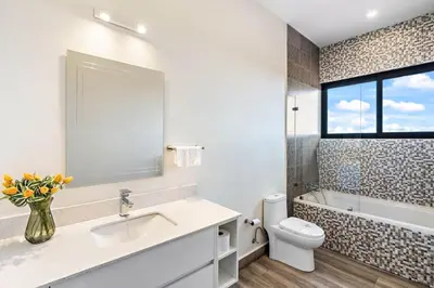 a bathroom with a sink and a toilet and a window at Mountaintop 4-Bedroom with Pool Huge Views in Carpintero