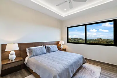 a bedroom with a bed and a large window at Mountaintop 4-Bedroom with Pool Huge Views in Carpintero