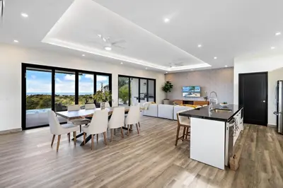 a kitchen and dining room with a table and chairs at Mountaintop 4-Bedroom with Pool Huge Views in Carpintero
