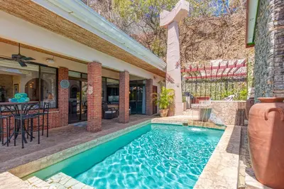 a swimming pool in the backyard of a house at Oceanview Villa with Wrap-Around Terrace, Private Pool, Hot Tub, and Guesthouse in Playa Flamingo
