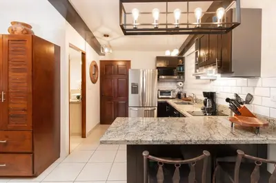 a kitchen with a large counter top in a room at Modern Studio Apartment with Covered Balcony, Full Kitchen, and Stunning Ocean Views in Playa Flamingo