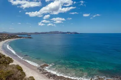 an aerial view of a beach with turquoise water at Modern Studio Apartment with Covered Balcony, Full Kitchen, and Stunning Ocean Views in Playa Flamingo
