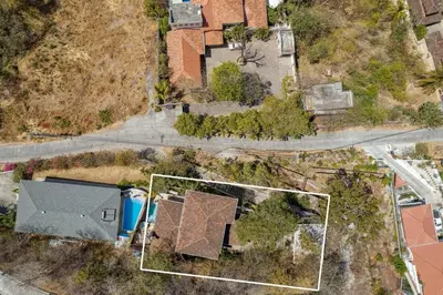 an aerial view of a house with a yard at Modern Studio Apartment with Covered Balcony, Full Kitchen, and Stunning Ocean Views in Playa Flamingo