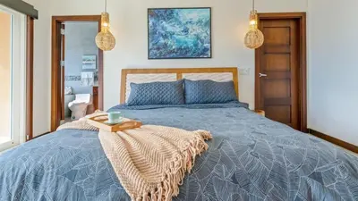 a bedroom with a bed with a tray on it at Beautiful House with Sweeping Ocean Views, Modern Design, and a Private Infinity Pool in Potrero