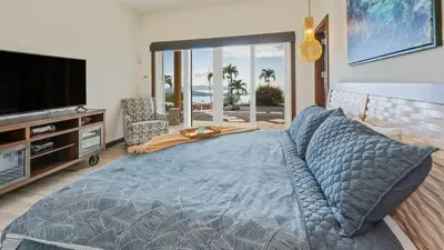 a bedroom with a bed and a flat screen tv at Beautiful House with Sweeping Ocean Views, Modern Design, and a Private Infinity Pool in Potrero