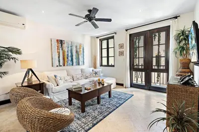 a living room with a white couch and a table at Stylish Beach-Themed Condo with Two Bedrooms and Lovely Ocean Views in Playa Danta