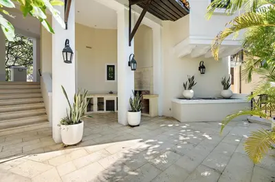 a courtyard of a house with potted plants at Stylish Beach-Themed Condo with Two Bedrooms and Lovely Ocean Views in Playa Danta