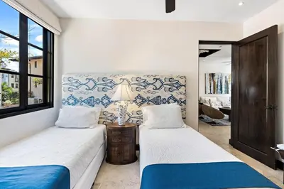 a bedroom with two beds and a window at Stylish Beach-Themed Condo with Two Bedrooms and Lovely Ocean Views in Playa Danta