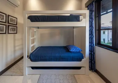 a bedroom with two bunk beds with blue sheets at Beautiful Mediterranean-Style Penthouse with an Oceanview Balcony in Playa Danta