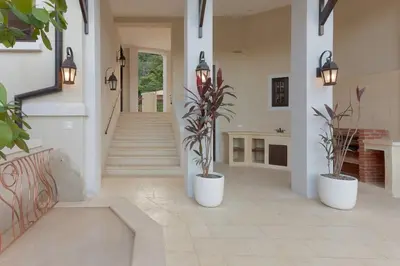 a hallway with two potted plants in a house at Beautiful Mediterranean-Style Penthouse with an Oceanview Balcony in Playa Danta