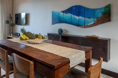 a wooden table with a bowl of fruit on it at Beautiful Mediterranean-Style Penthouse with an Oceanview Balcony in Playa Danta