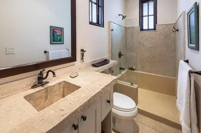 a bathroom with a sink and a shower and a toilet at Beautiful Mediterranean-Style Penthouse with an Oceanview Balcony in Playa Danta