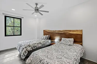 a bedroom with two beds and a ceiling fan at Stunning Top-Floor Condo with Sweeping Ocean & Mountain Views & Beach Club in Coco
