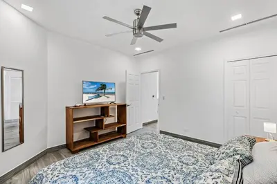 a bedroom with a bed and a ceiling fan at Stunning Top-Floor Condo with Sweeping Ocean & Mountain Views & Beach Club in Coco