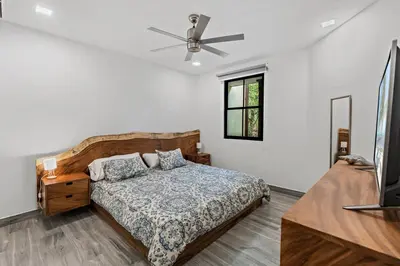 a bedroom with a bed and a ceiling fan at Stunning Top-Floor Condo with Sweeping Ocean & Mountain Views & Beach Club in Coco